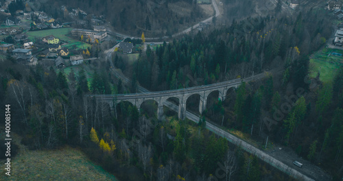 Magical aerial panorama of mystical Glebce viaduct close to Wisla, Poland in late autumn weather. Mysterious train bridge. photo