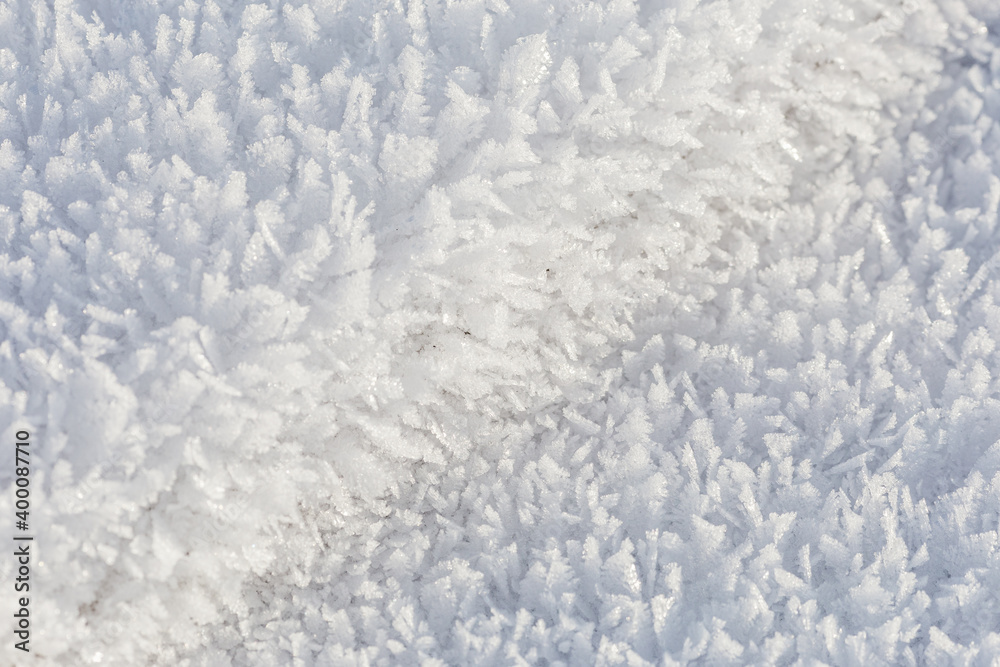 Winter, snow and frost, surface structure of a winter landscape with large crystals, space texture, white background.