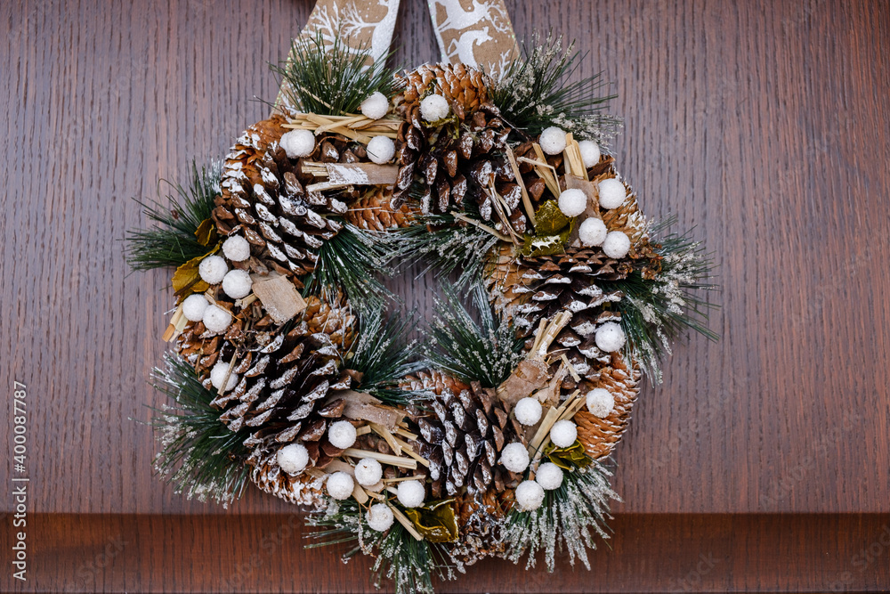 December 2020 - Milan: Christmas wreath hanging on a wooden door December 2020 - Milan: Christmas wreath hanging on a wooden door