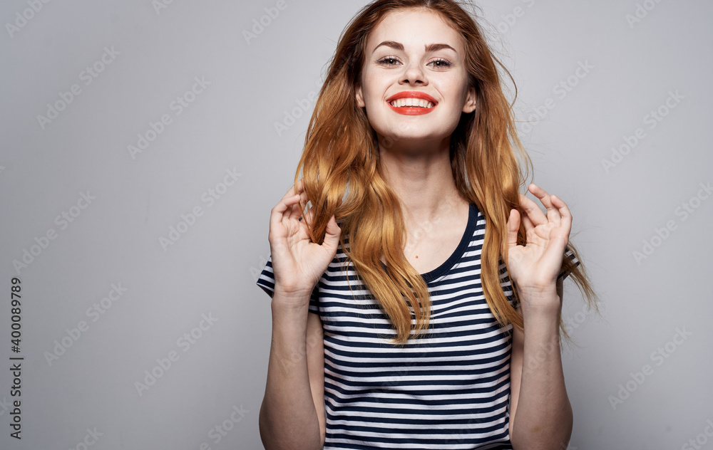 Cheerful pretty woman striped t-shirt glamor smile cosmetics emotions isolated background Cheerful pretty woman striped t-shirt glamor smile cosmetics emotions isolated background