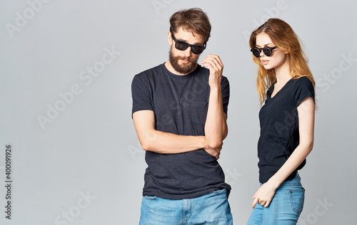 young couple in black t-shirts sunglasses studio romance communication elegant style