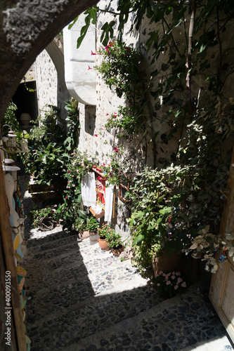 Fototapeta Naklejka Na Ścianę i Meble -  Traditional narrow stair street leading to the sea. Oia village, in Santorini Island, Greece. Landscape Greek islands