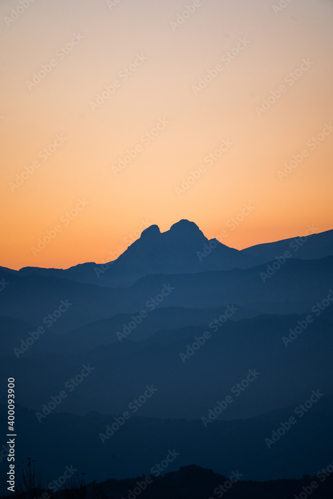 Mountain range at sunset or sunrise from the peak and of a magical mountain, vertical. Pedraforca, Bergueda, Barcelona, Catalonia, Spain. Serra del Cadí - Natural Park Cadí-Moixeró, Pyrenees-Pirineus.