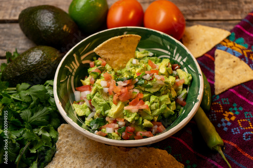 Mexican guacamole on wooden background