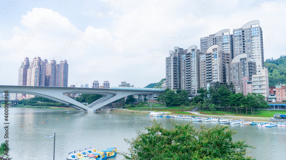 Cityscape of Xindian City, Taiwan. Tall buildings, bridge and river.