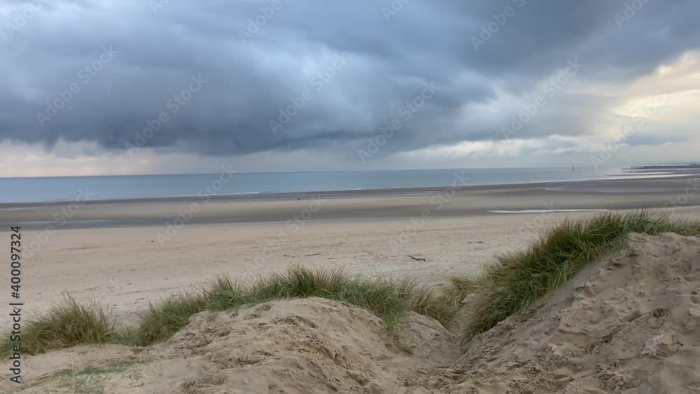 Camber sands beach, Rye, East Sussex UK, Camber is a flat sandy beach with giant sand dunes South coast England and popular with tourists and daytrippers in only sand dune system in East Sussex, Uk Camber sands beach, Rye, East Sussex UK, Camber is a flat sandy beach with giant sand dunes South coast England and popular with tourists and daytrippers in only sand dune system in East Sussex, Uk