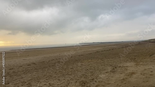 sunset beach storm beach camber sands in East Sussex, UK sand dunes pan to sunset low tide flat sandy beach 
