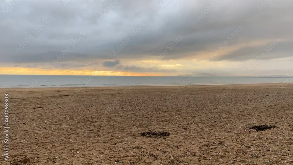 time lapse couple walking on beach storm beach camber sands in East Sussex, UK time lapse couple walking on beach storm beach camber sands in East Sussex, UK