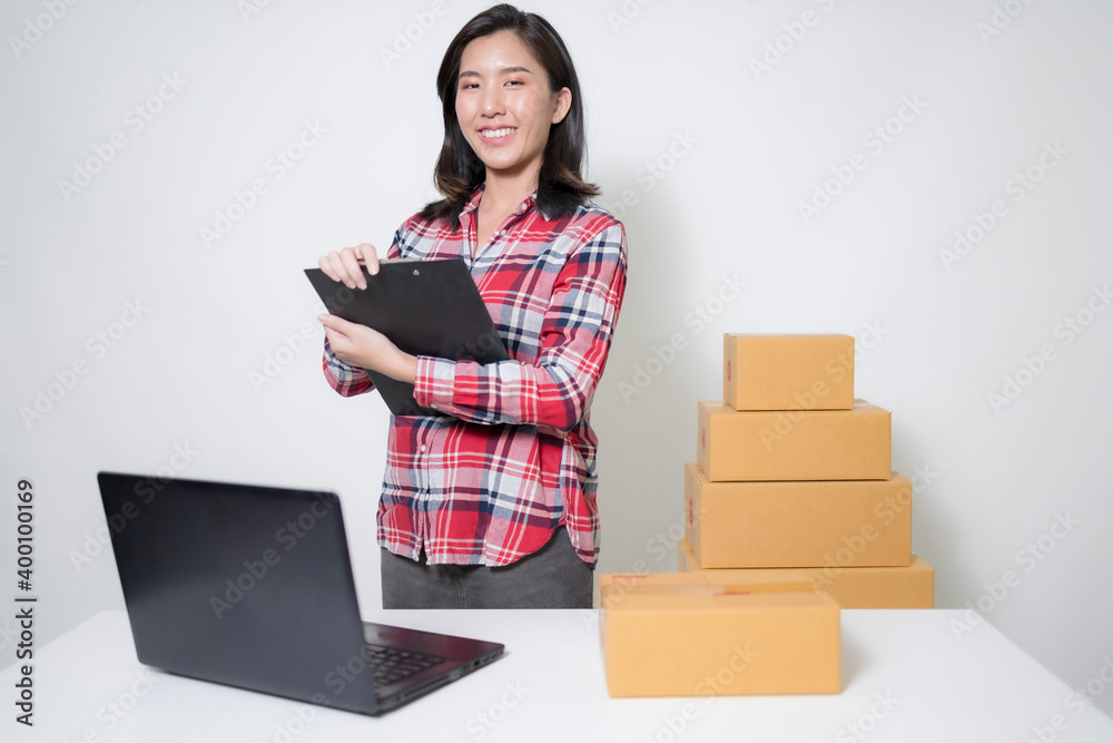 Asian women with startup small business entrepreneur freelance working at home and excited about the orders of many customers, Online marketing packing box delivery concept. Asian women with startup small business entrepreneur freelance working at home and excited about the orders of many customers, Online marketing packing box delivery concept.