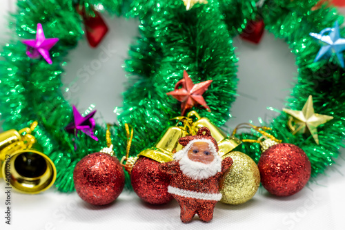 Close-up shot of Santa Claus wearing a Christmas garland adorned with ornaments