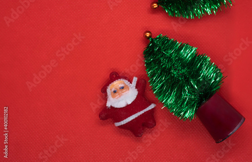 Top view Christmas tree with Santa Claus on red studio background. copy space © avs