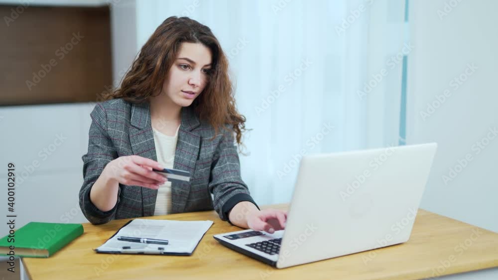 Portrait caucasian female sit at table at home make online payment purchase using credit card, happy young woman shopping on internet, pay on web with secure banking service system on laptop Portrait caucasian female sit at table at home make online payment purchase using credit card, happy young woman shopping on internet, pay on web with secure banking service system on laptop