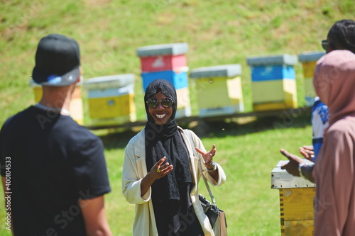 woman giving presentation to group of business investors on local honey production farm