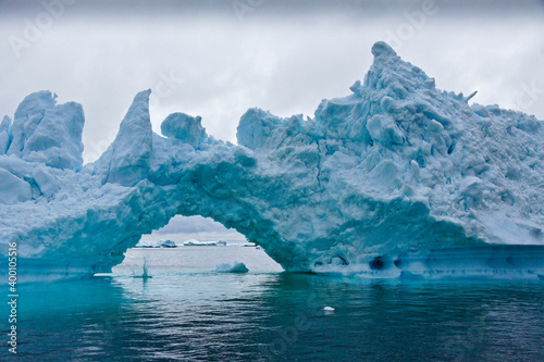 Iceberg arch in Disko Bay, Ilulissat, West Greenland photo