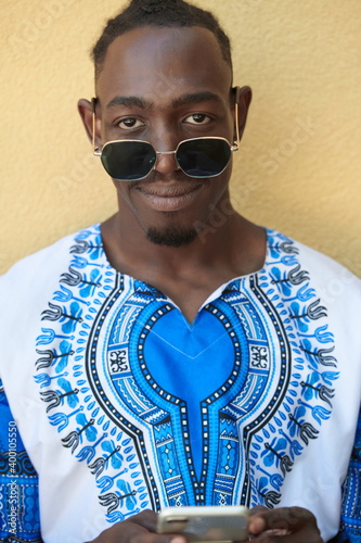 portrait of a smiling young african man wearing traditioinal clothes photo