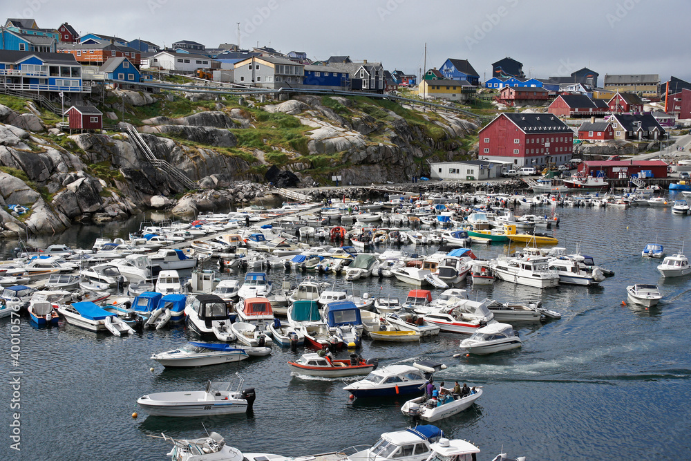 Colorful buildings overlook the fishing harbor in Ilulissat, West Greenland.