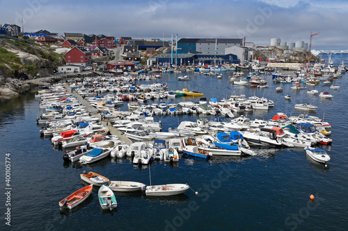 Fishing boats of all sizes crowd the tiny harbor in Ilulissat, West Greenland. photo