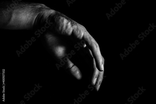 Hand. Hand of a sleeping man on a dark background close-up.