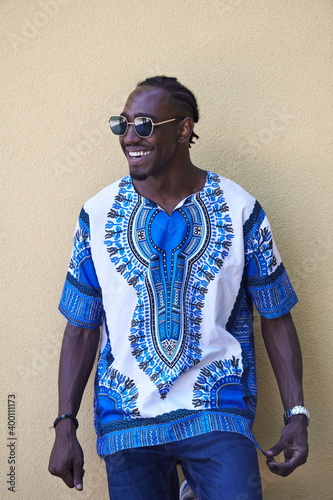 portrait of a smiling young african man wearing traditioinal clothes