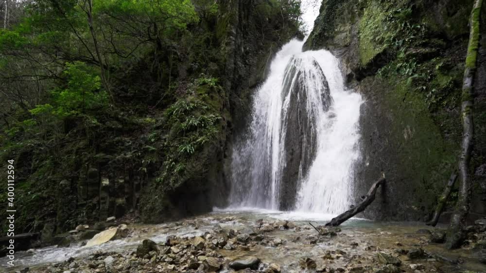 Beautiful view of waterfall falling through the rocks.