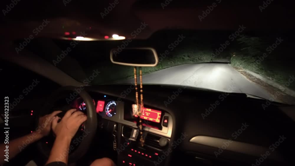 Driving during rain. POV view of car driving on road of highway at night
