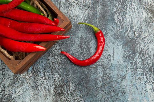 top view colored spicy peppers on a dark-light background pepper ripe photo free space for text