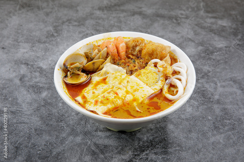 Delicious homemade curry noodles ( mee kari ) serve with seafood and egg