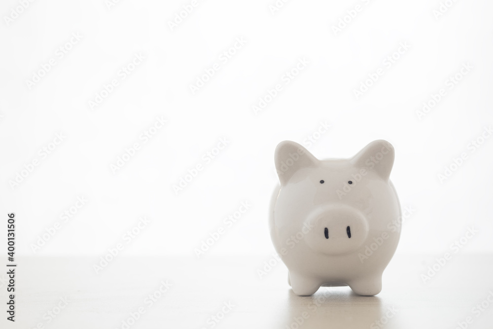 White piggy bank on table white background and copy space, concept of saving money. White piggy bank on table white background and copy space, concept of saving money.