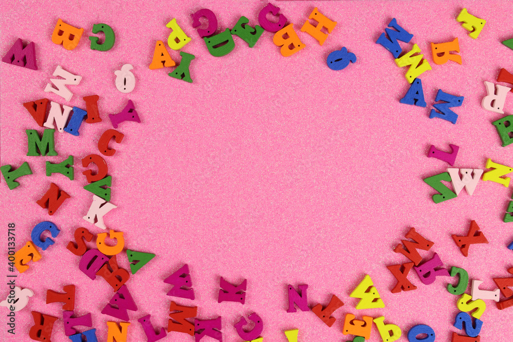 colorful letters of the english alphabet scattered on a pink background. Flat Lay. copy space colorful letters of the english alphabet scattered on a pink background. Flat Lay. copy space