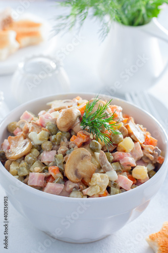 Olivier with champignons, Russian salad with vegetables and mushrooms, selective focus