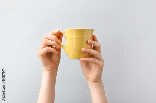 Hands with cup on white background