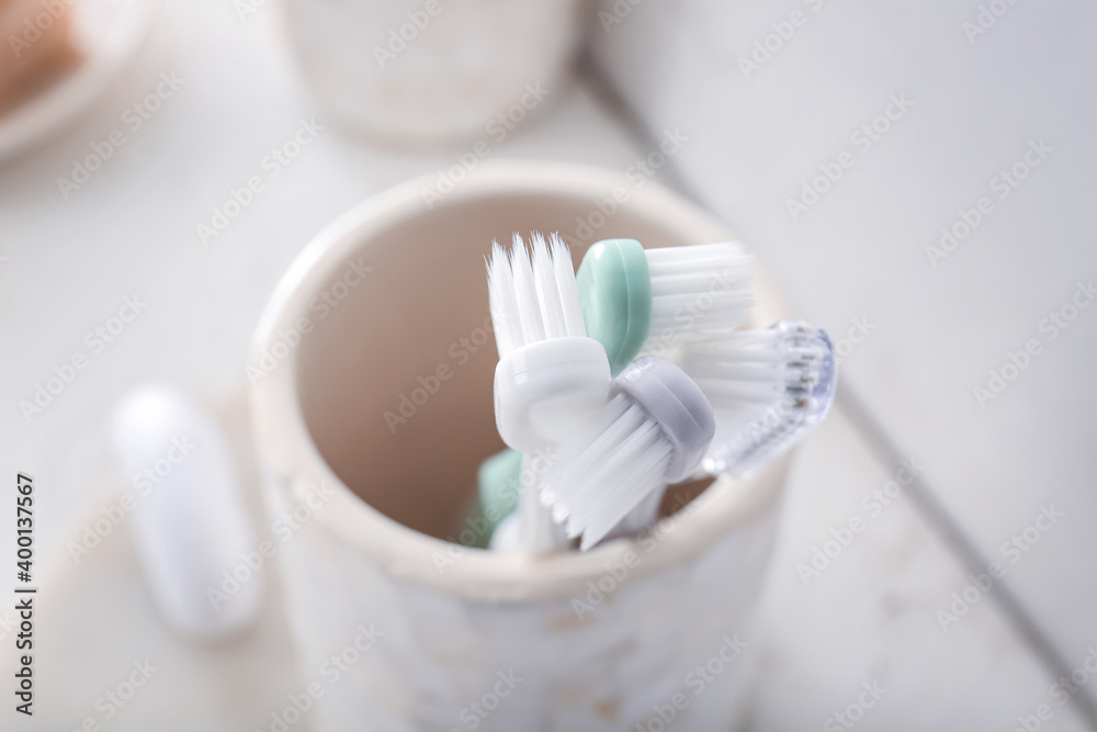 Holder with toothbrushes on table in bathroom Holder with toothbrushes on table in bathroom