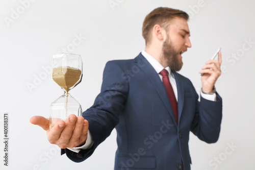 Angry businessman with hour...