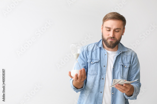 Young man with hourglass an...