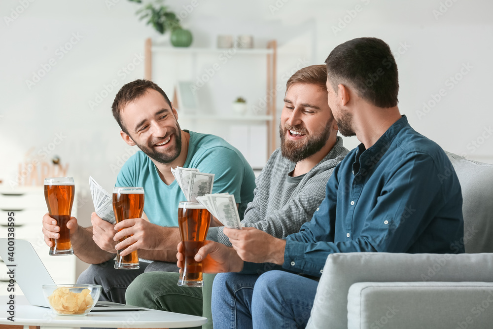 Happy men after winning of their sports bets at home Happy men after winning of their sports bets at home