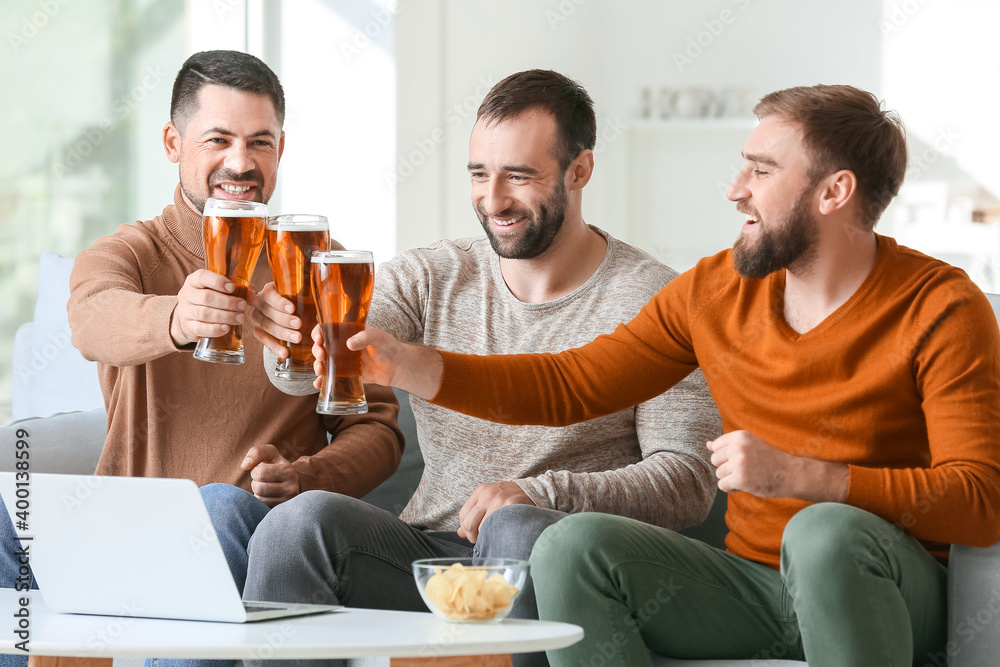 Happy men after winning of their sports bets at home Happy men after winning of their sports bets at home