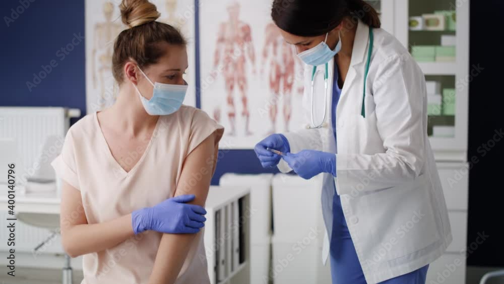 Handheld video of female doctor vaccinates a patient. Shot with RED helium camera in 8K. Handheld video of female doctor vaccinates a patient. Shot with RED helium camera in 8K.