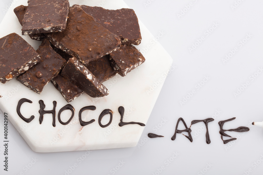 Broken or cracked chocolate chips pieces isolated on white background. Broken or cracked chocolate chips pieces isolated on white background.