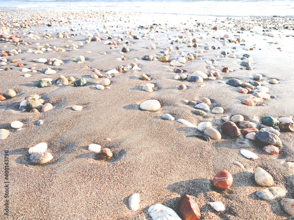 Beautiful pebbles on the sand, beach background Beautiful pebbles on the sand, beach background