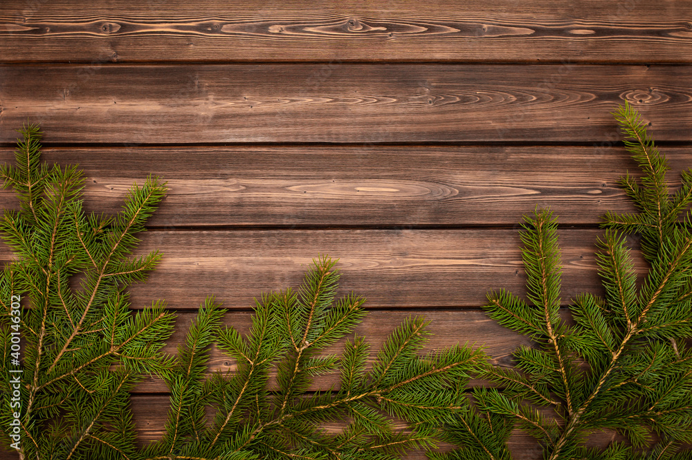Christmas tree on a wooden background top view. Festive background for the new year 2021. Elegant card decor for Christmas greetings. Christmas tree on a wooden background top view. Festive background for the new year 2021. Elegant card decor for Christmas greetings.