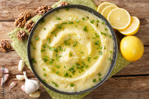 Delicious Greek Skordalia made from mashed potatoes with garlic, lemon, nuts and olive oil close-up in a plate on the table. horizontal top view from above photo