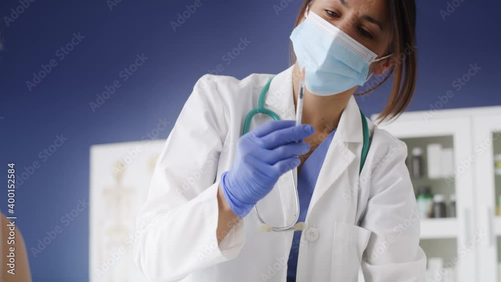 Handheld video of female doctor giving shot to patient. Shot with RED helium camera in 8K. Handheld video of female doctor giving shot to patient. Shot with RED helium camera in 8K.