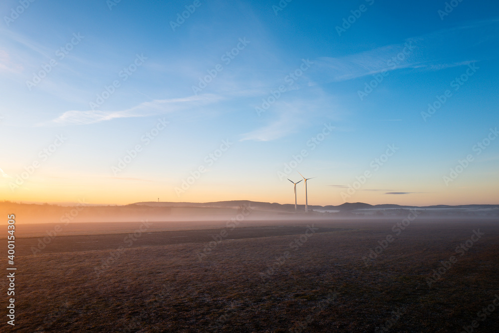 wind turbines on a misty morning