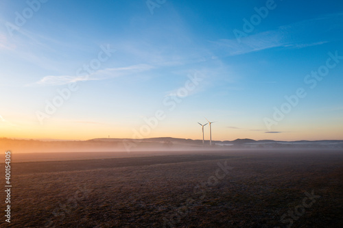 wind turbines on a misty morning