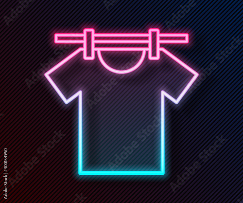 Glowing neon line Drying clothes icon isolated on black background. Clean shirt. Wash clothes on a rope with clothespins. Clothing care and tidiness. Vector.