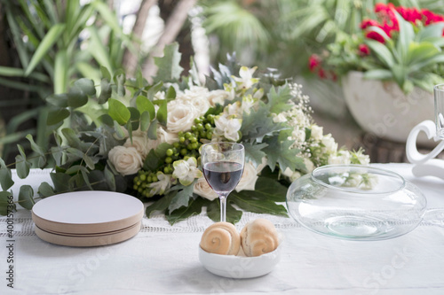Table setting for a wedding.  Wedding rings for Christian ceremony.  Wedding rings, wine and bread during a Christian ceremony.  Wedding bouquet.