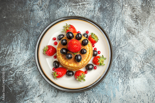 top view delicious pancakes with fruits and berries on dark background cake fruit dessert