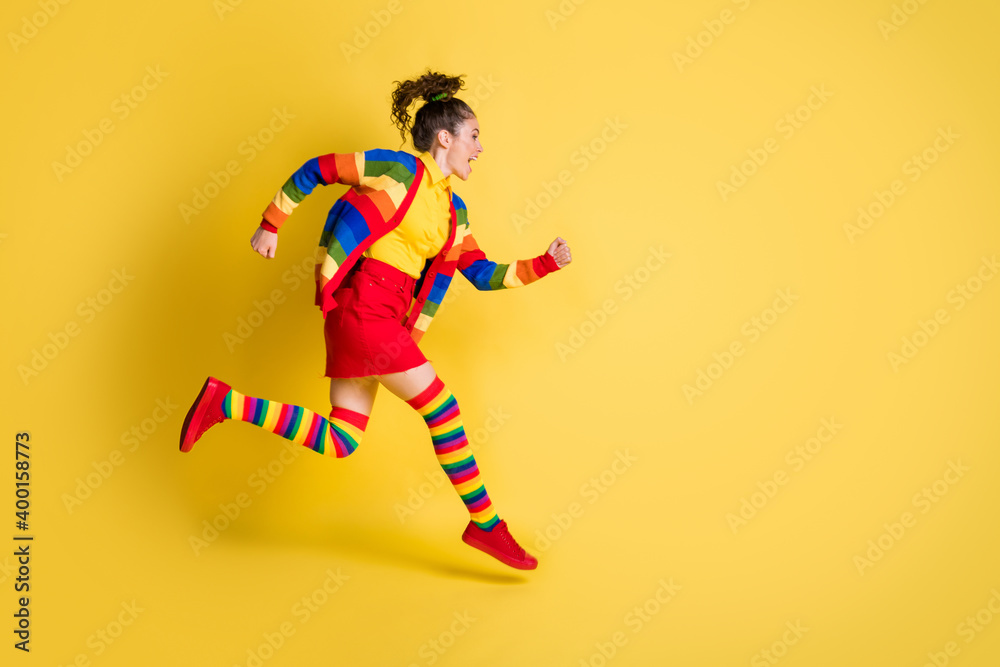 Full size profile side photo of crazy funky girl jump run wear rainbow skirt long socks isolated shine color background