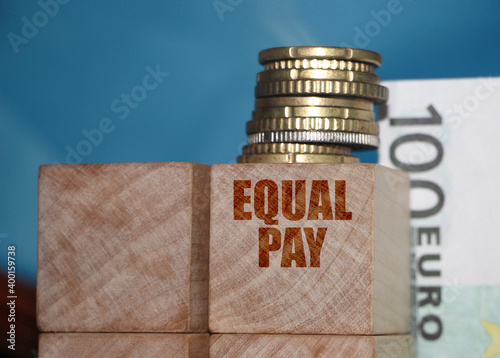 Equal pay words on wooden blocks. Income differences between men and women concept photo