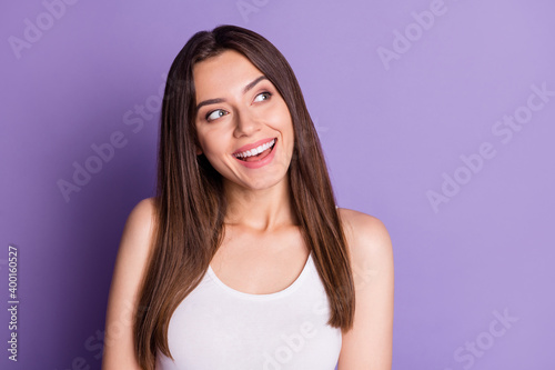 Photo of cute dreamy young woman wear casual white outfit looking empty space isolated violet color background